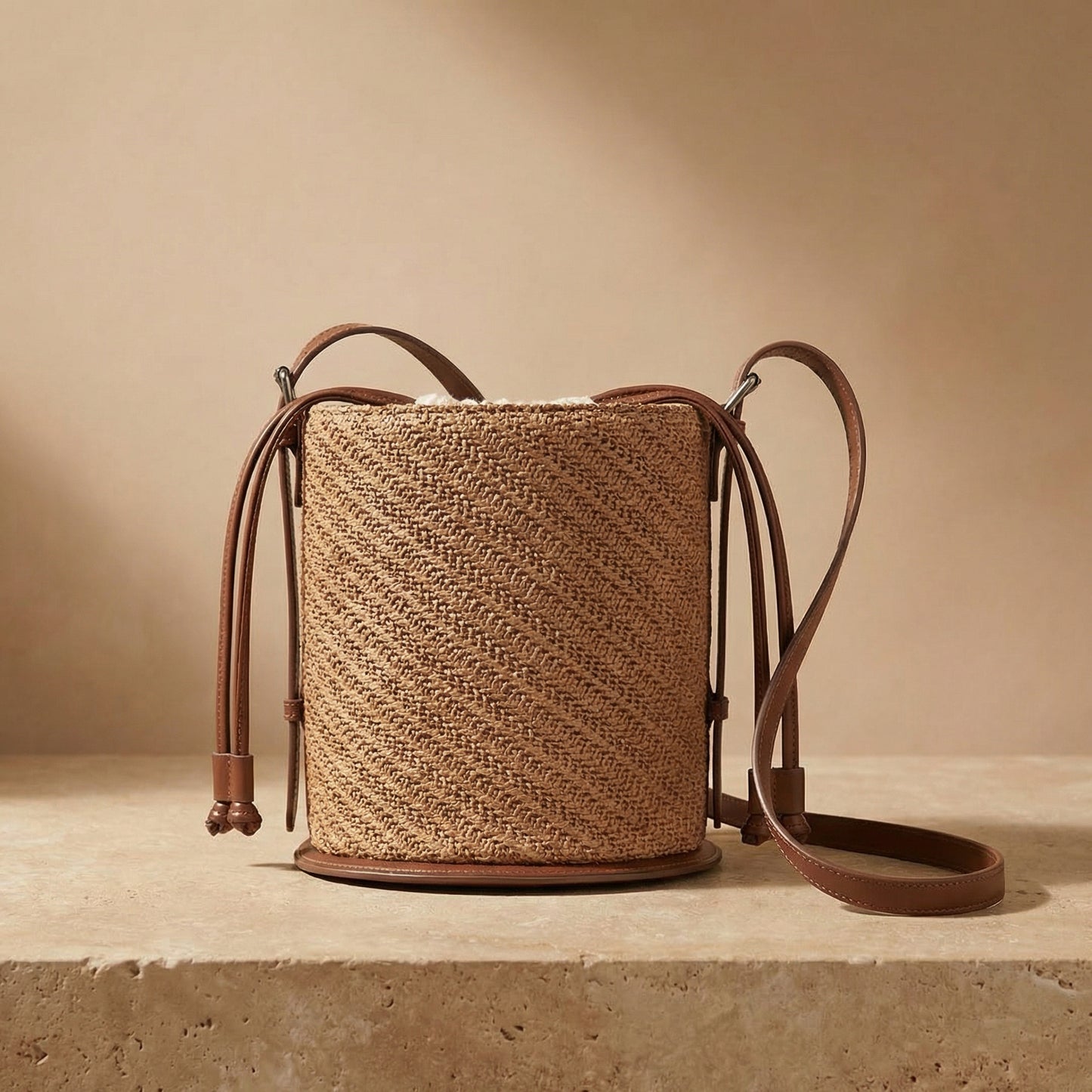 Woven bag with leather straps on a beige background