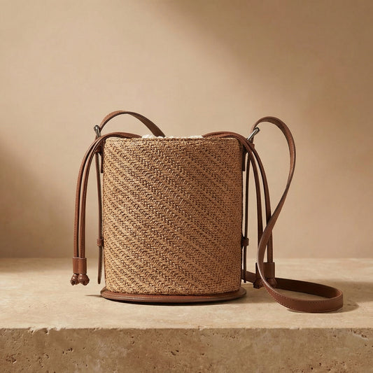 Woven bag with leather straps on a beige background