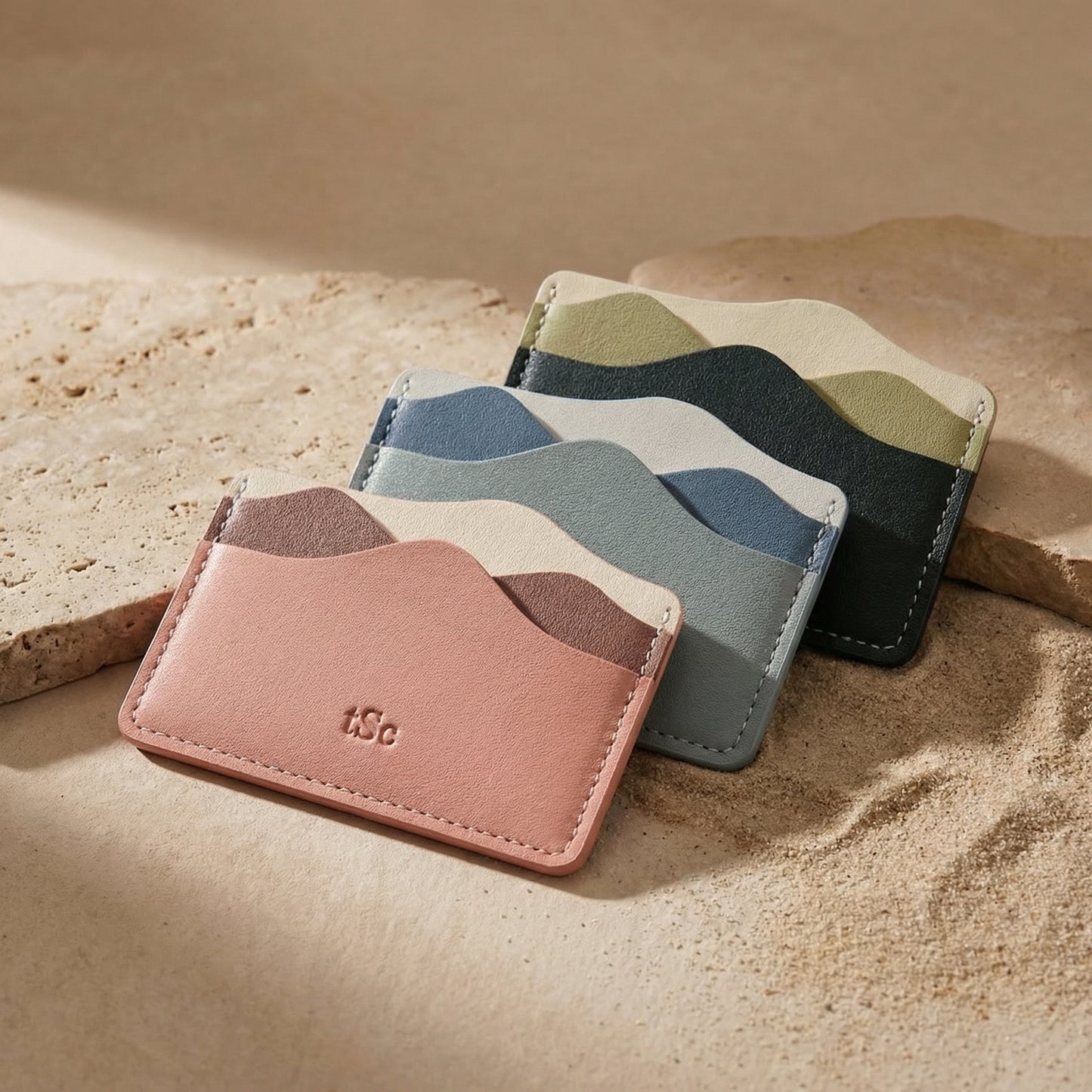 Three card holders with wavy pattern on a beige surface